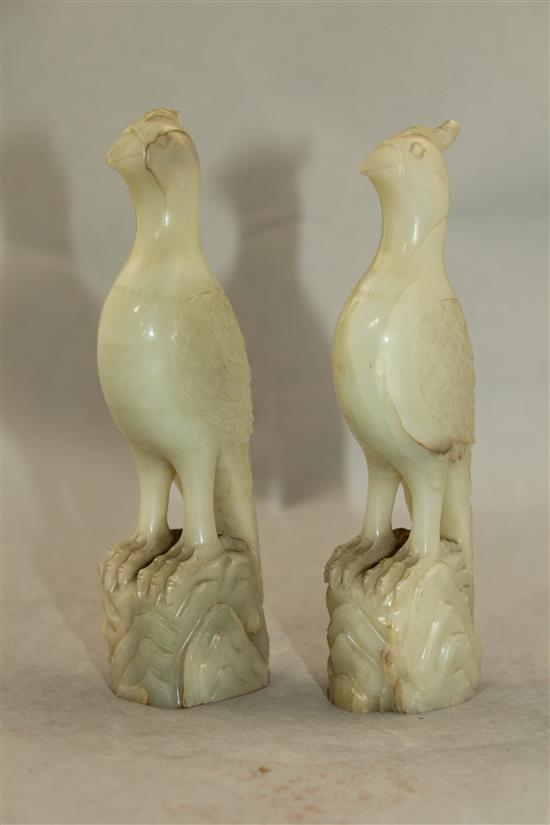 A pair of celadon-white jade standing figures of pheasants, 20th century, 4.3cm, chips to crests